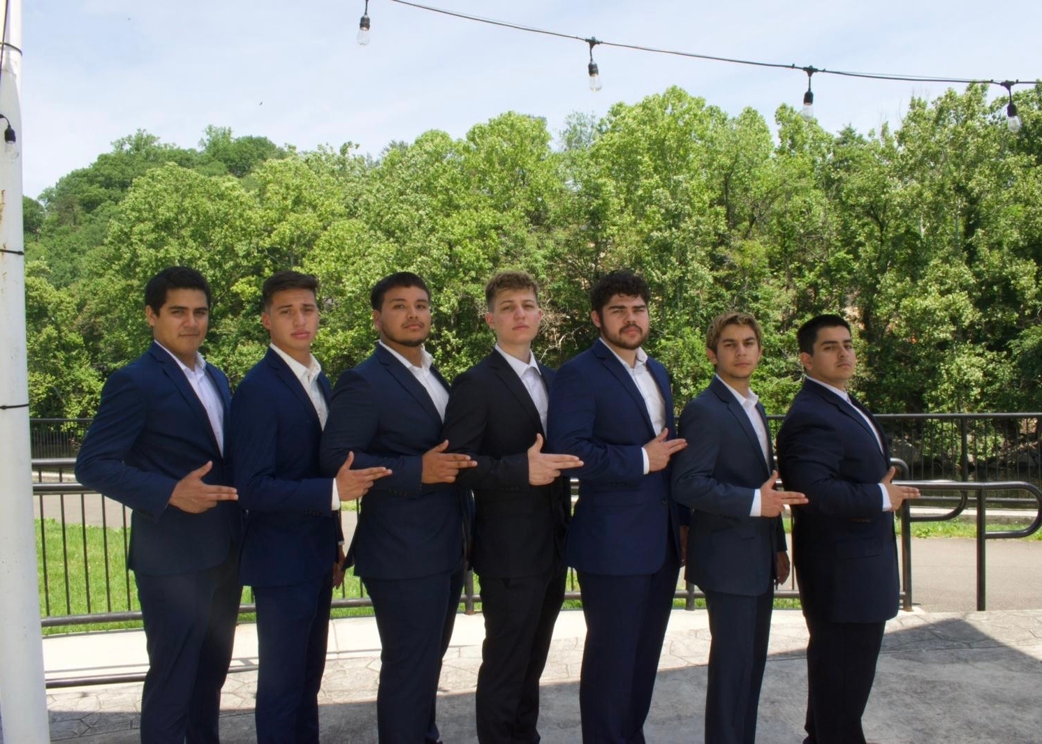 members of lambda upsilon lambda standing on stairs