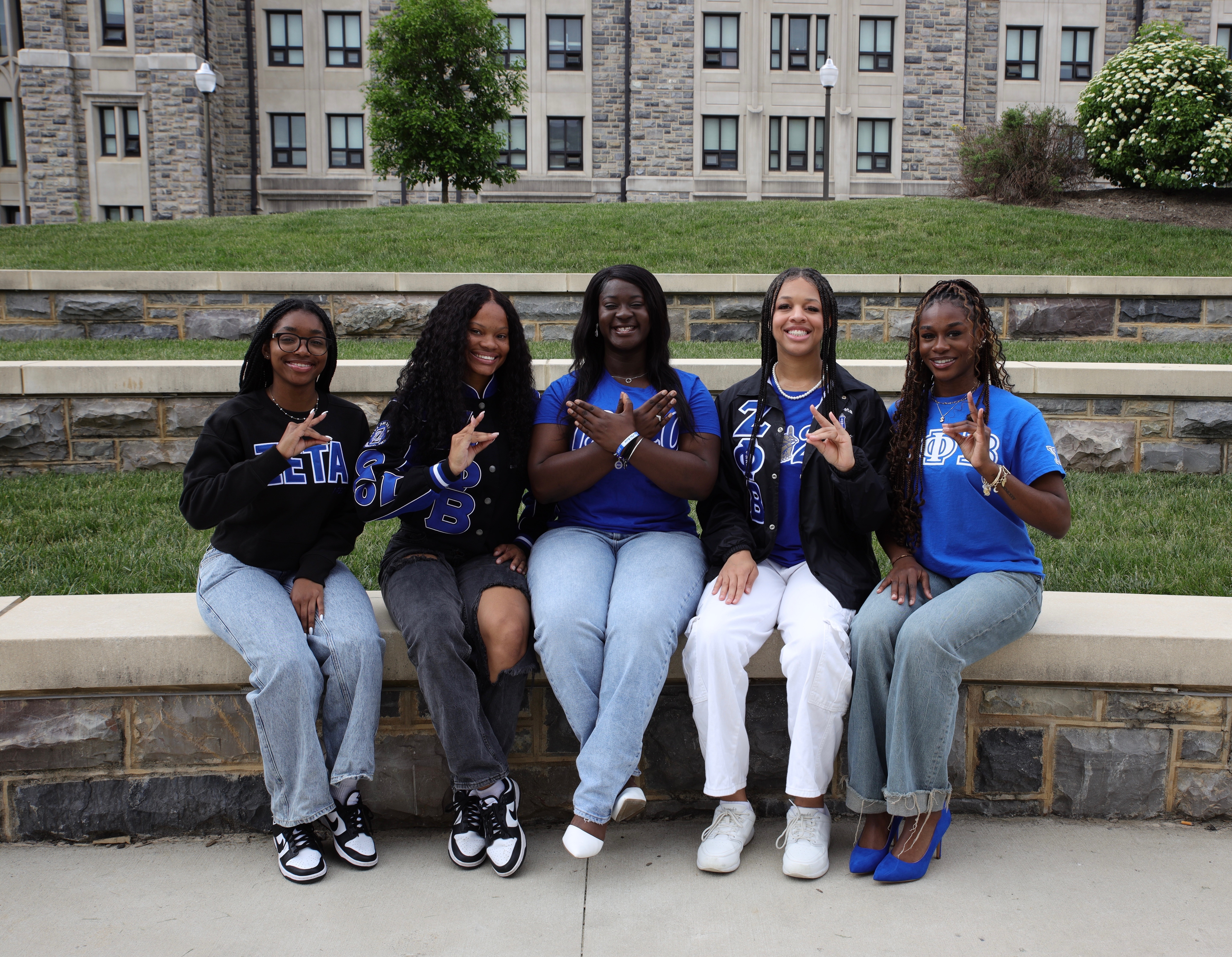 Members sitting outside on a bench